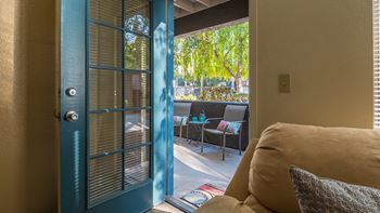 Estancia living room with private balcony and glass door